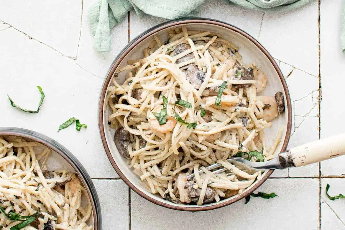 Mushroom shrimp pasta in bowls.