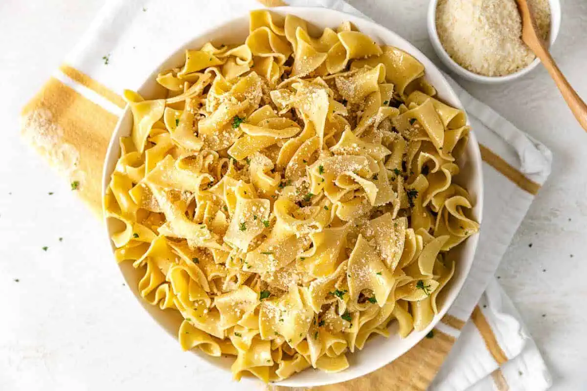 Butter parmesan noodles in a white bowl.