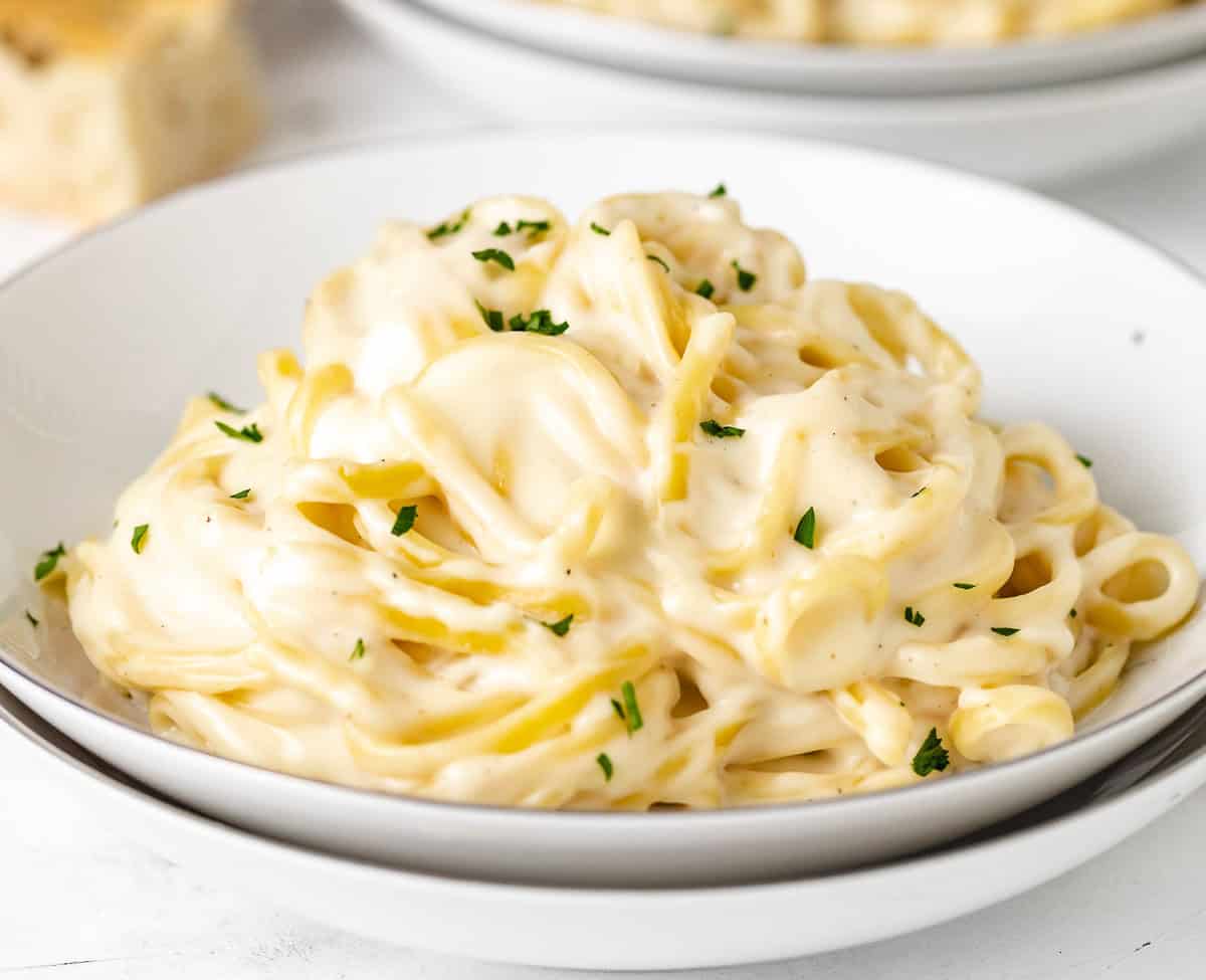 White dish holding garlic parmesan pasta.