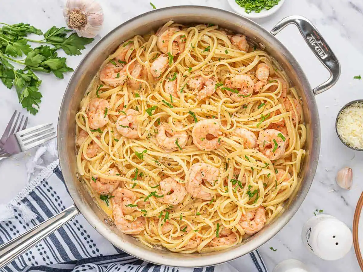 Top down view of a pan of garlic shrimp pasta.