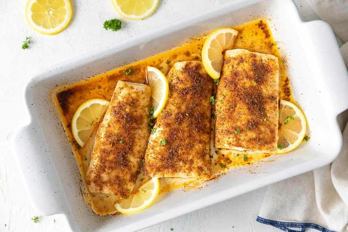 Top down view of a pan of baked mahi mahi.