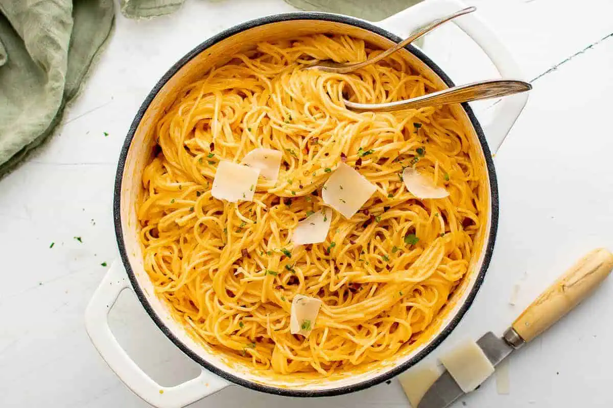 Pan of red pepper pasta with parmesan cheese.