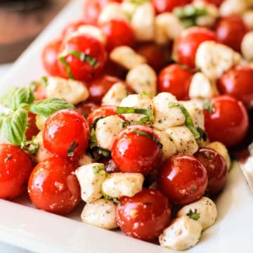 Close up view of tomato and mozzarella salad on a plate.