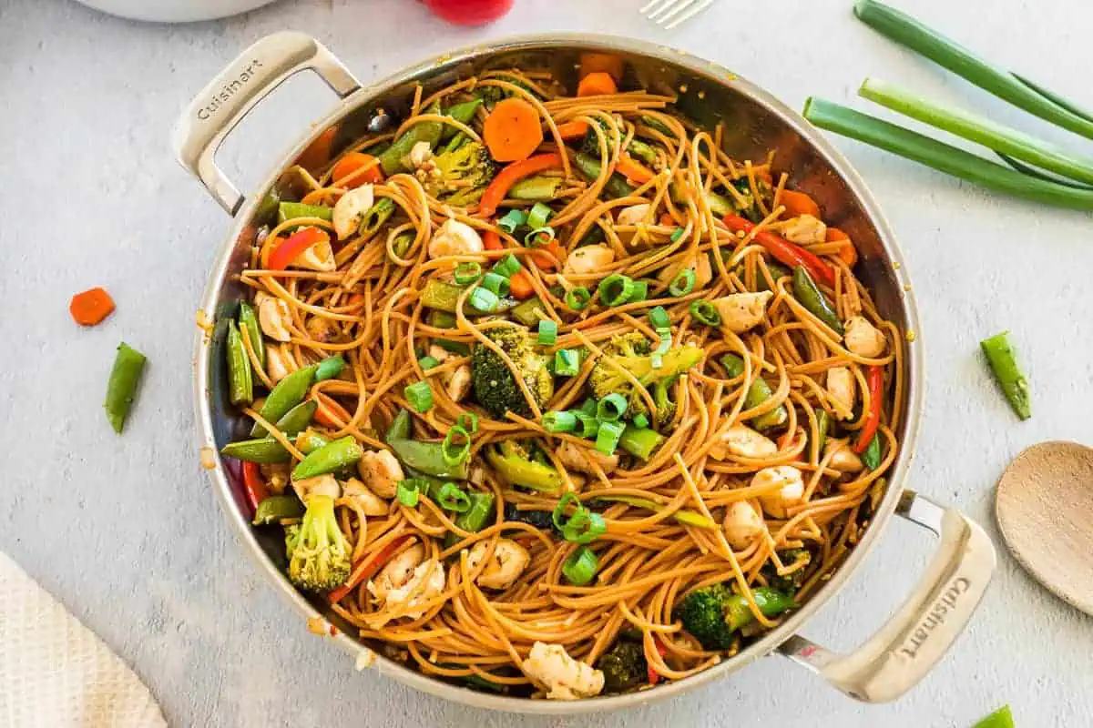 Chicken stir fry in a metal skillet.