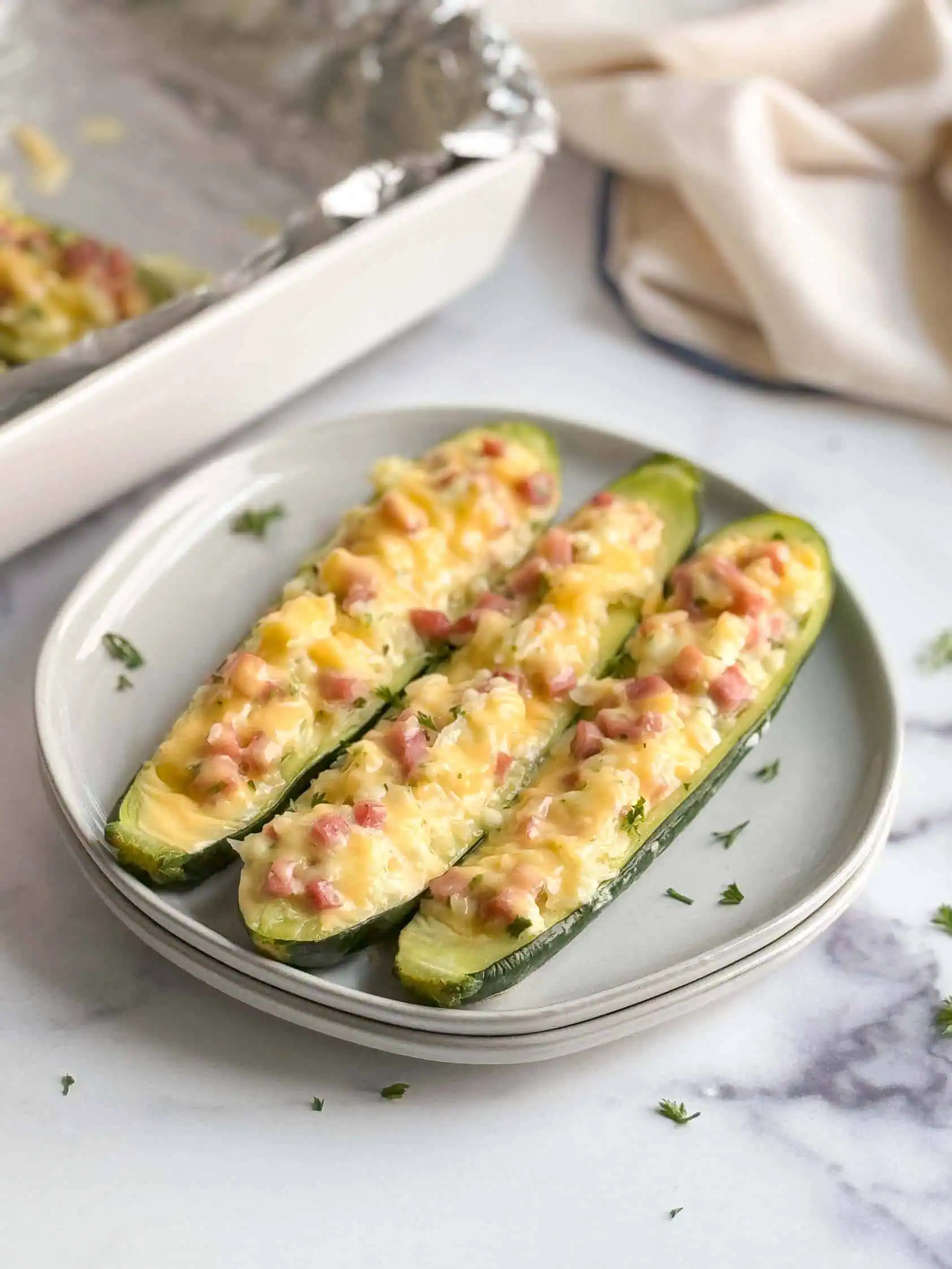 Stuffed zucchini on a gray plate.