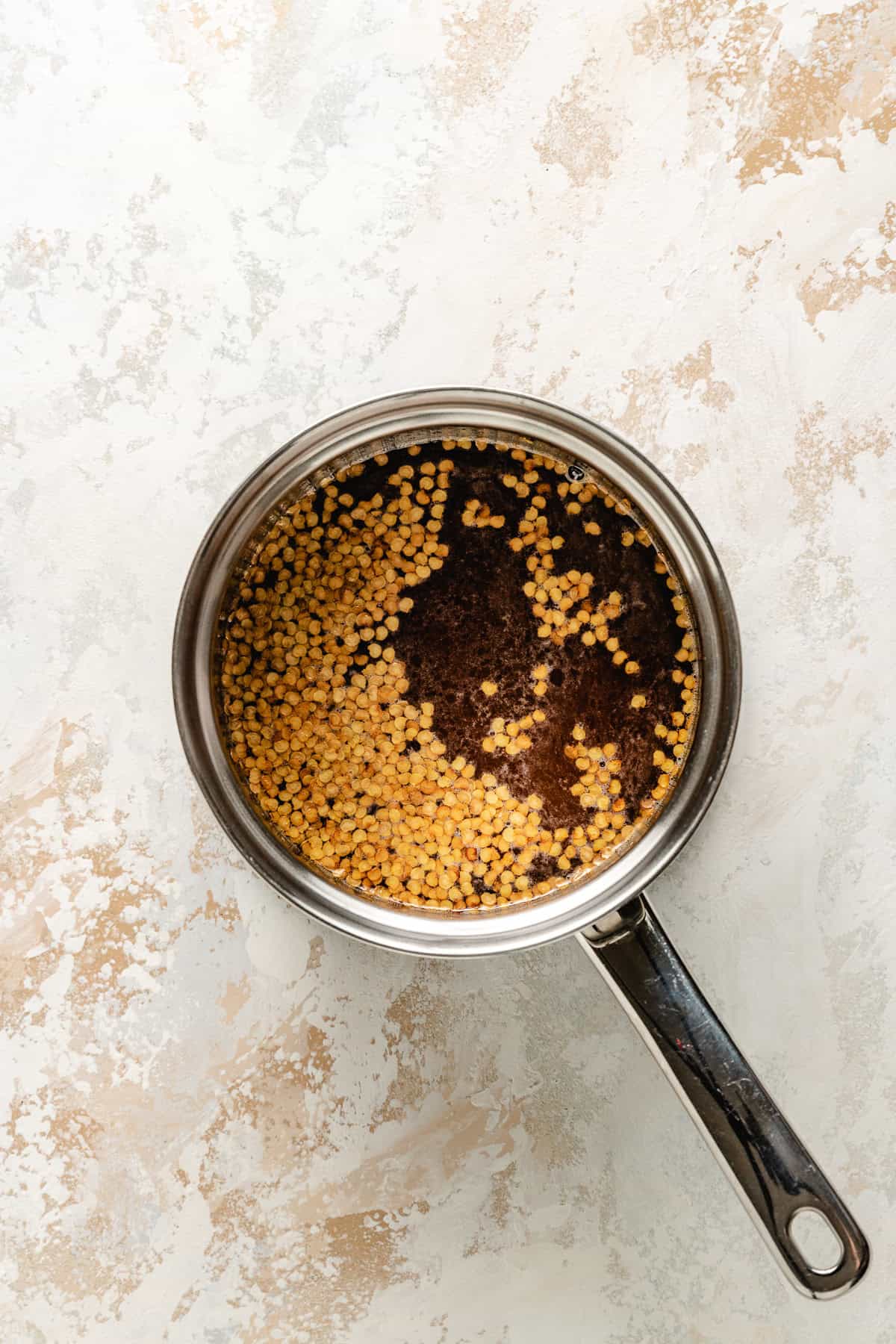 Honey with pepper flakes in a saucepan.