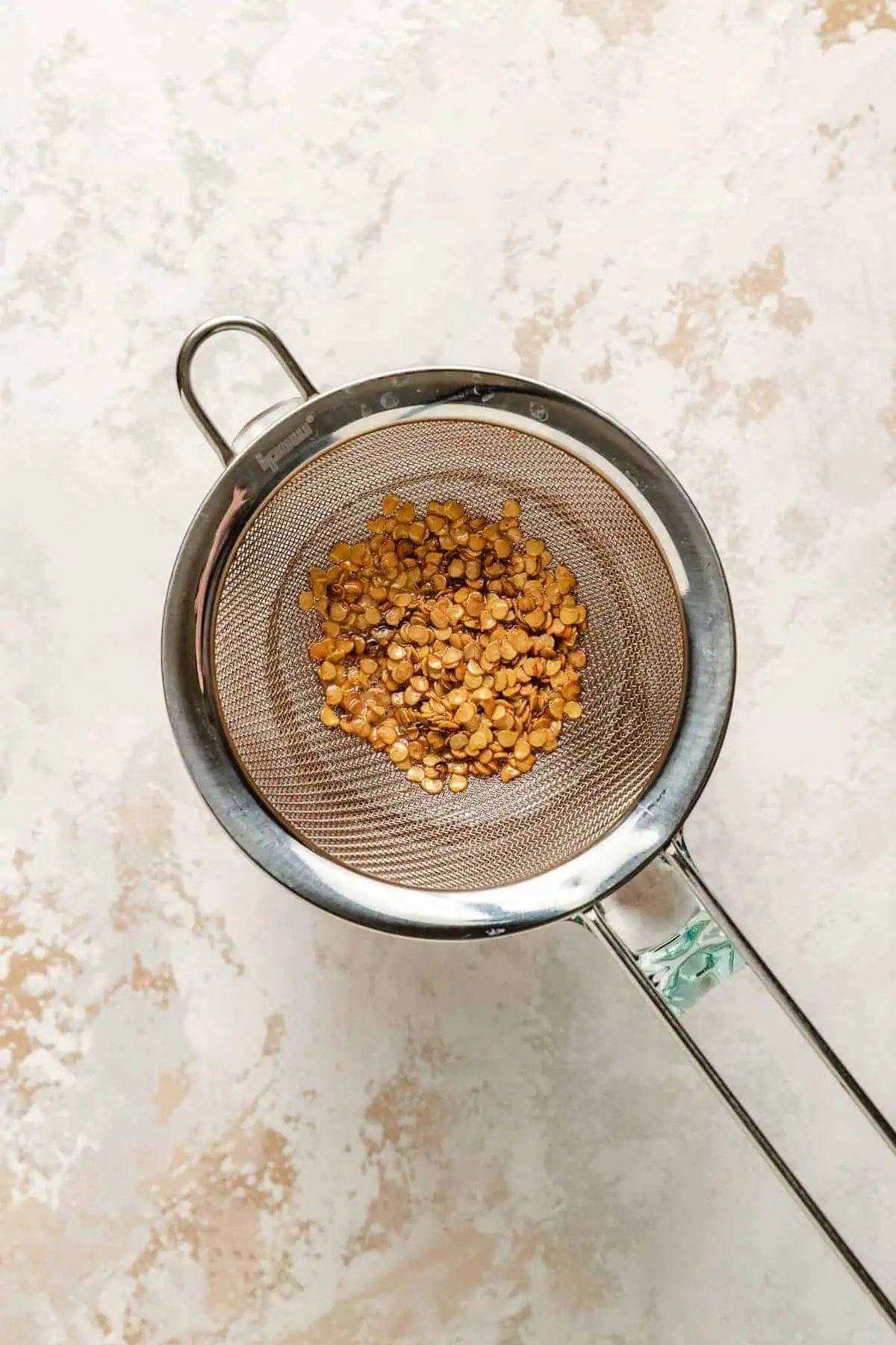 Honey poured through a mesh strainer.