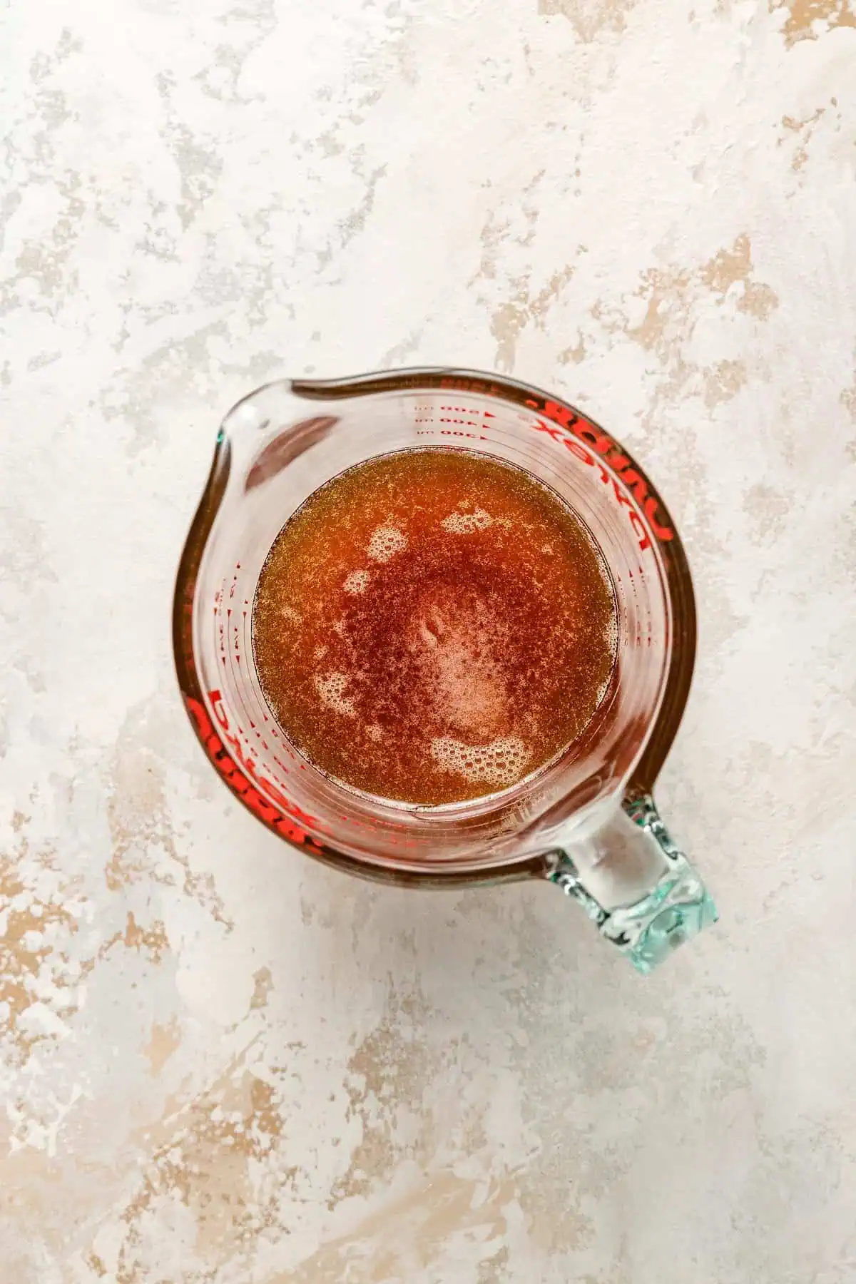 Hot honey in a measuring cup.