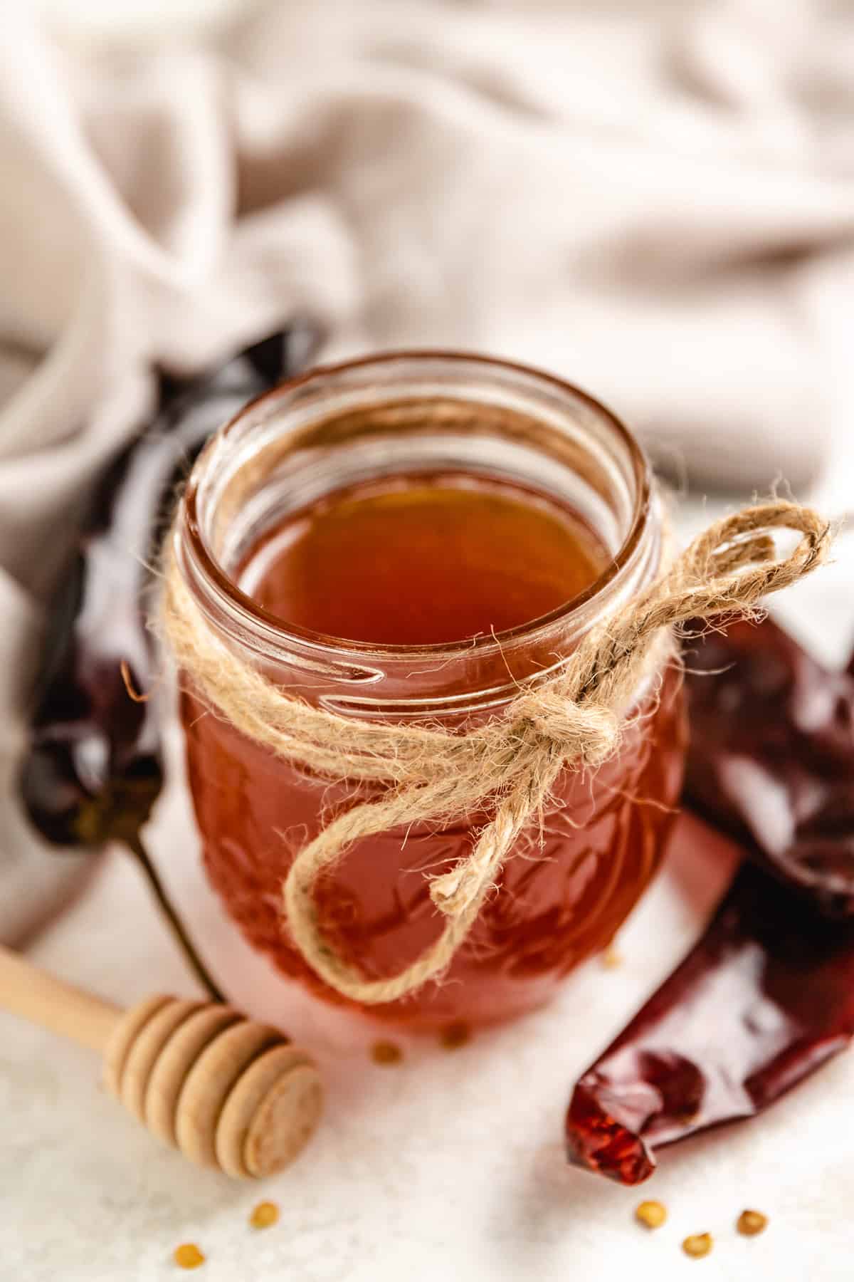 Twine tied around a jar of hot honey.