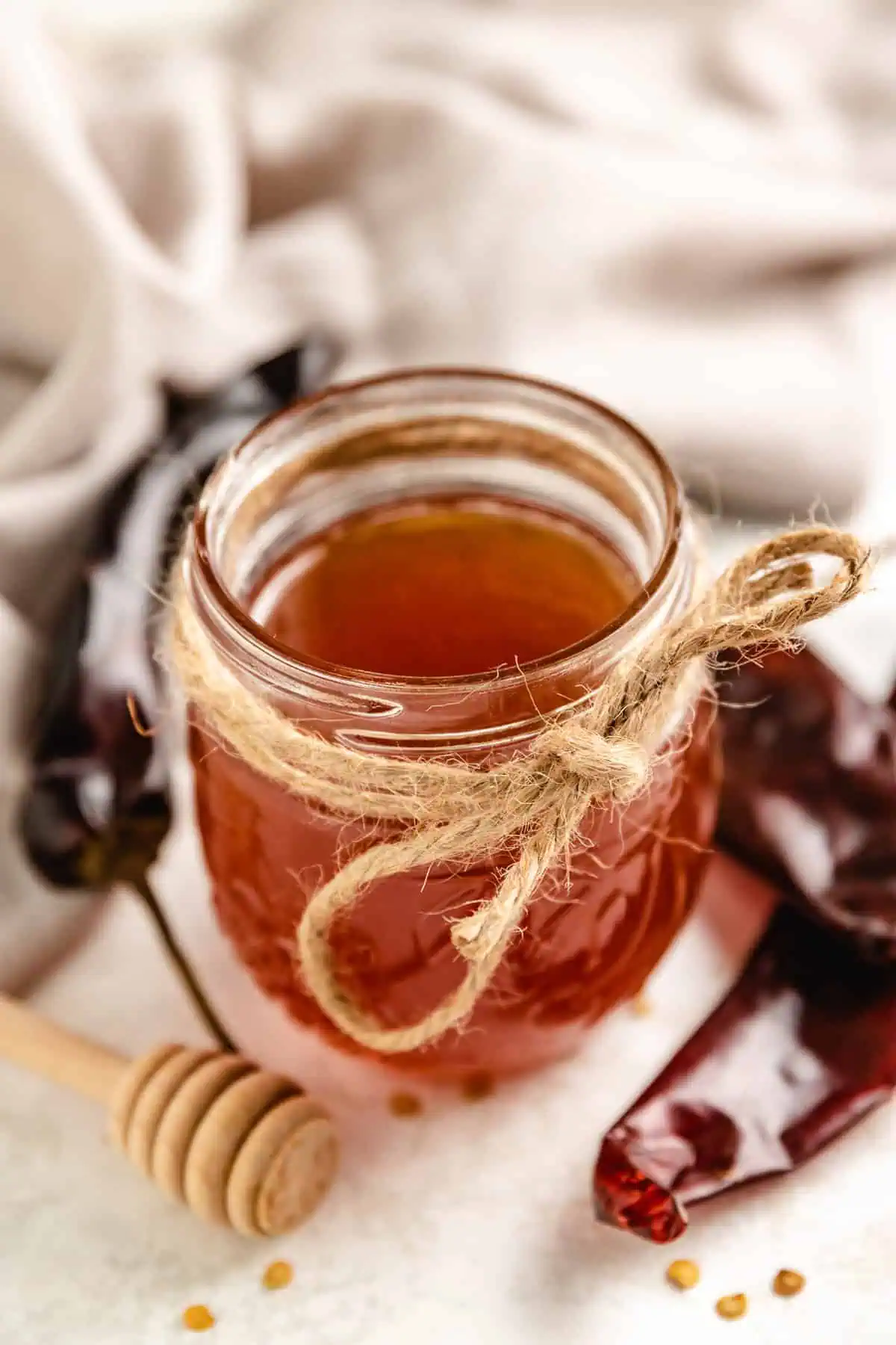 Twine tied around a jar of hot honey.