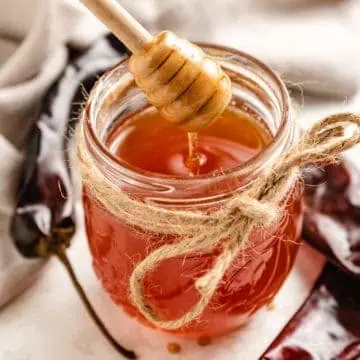 Honey being removed from a jar.