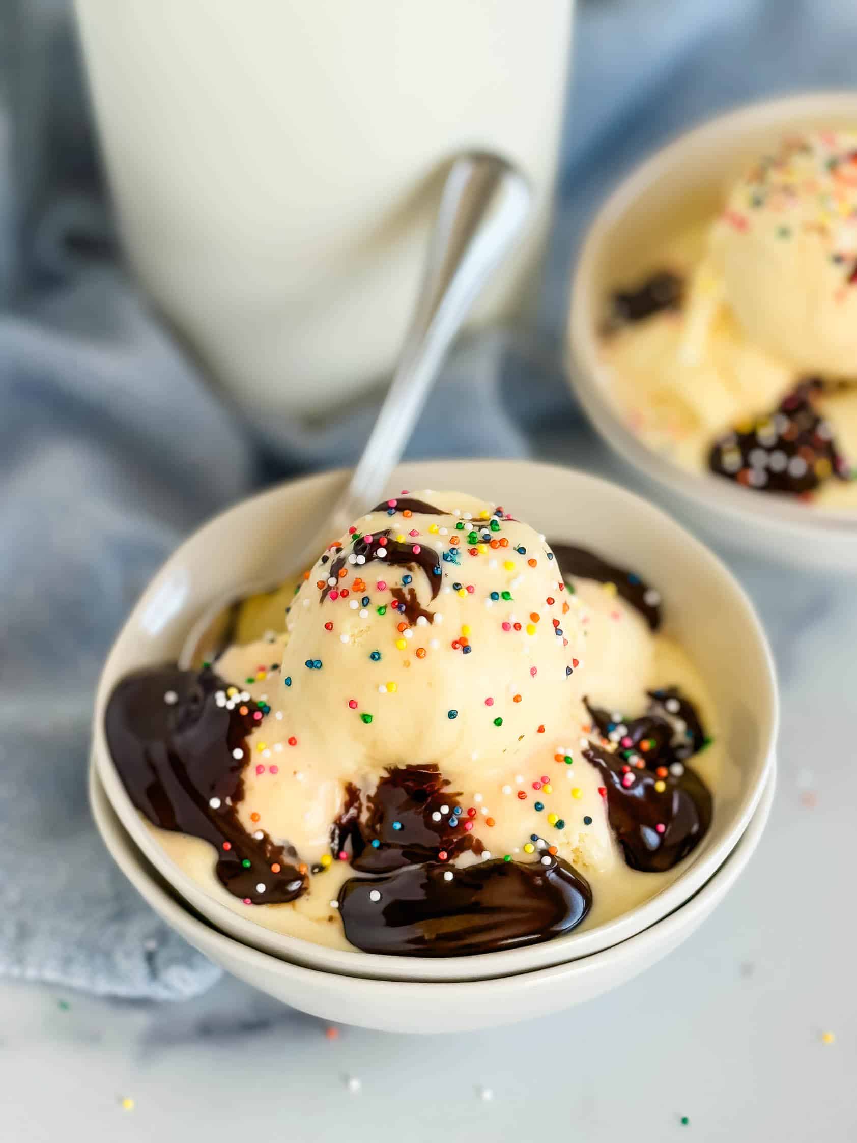 Hot fudge sauce poured over a bowl of ice cream.