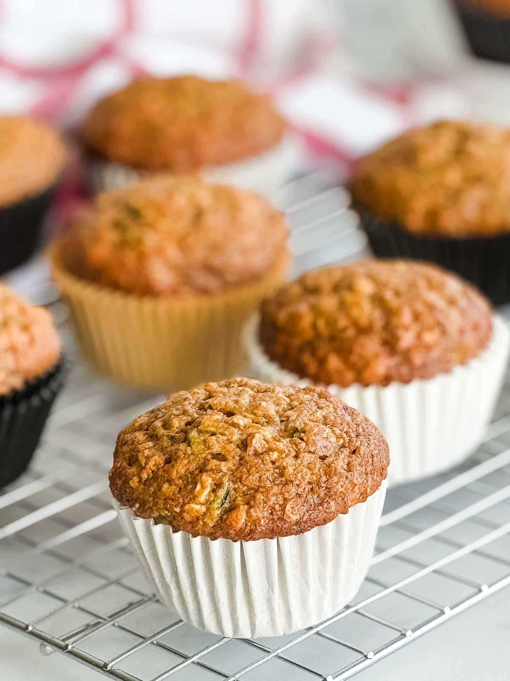 Wire rack holding freshly baked muffins.