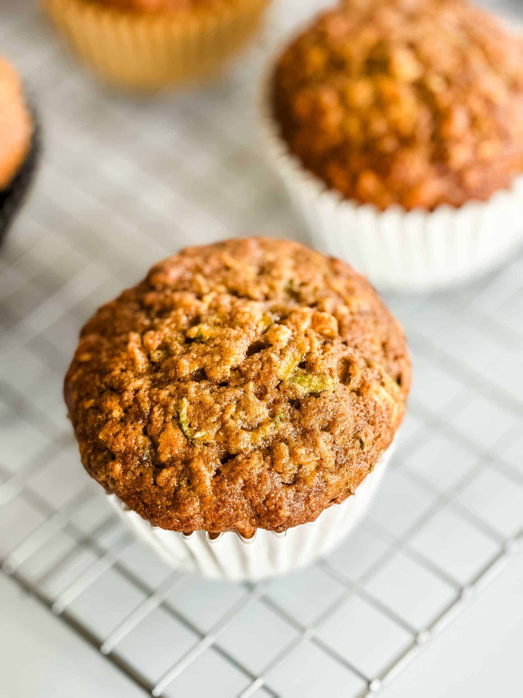 Top down view of a muffin on a cooling rack.