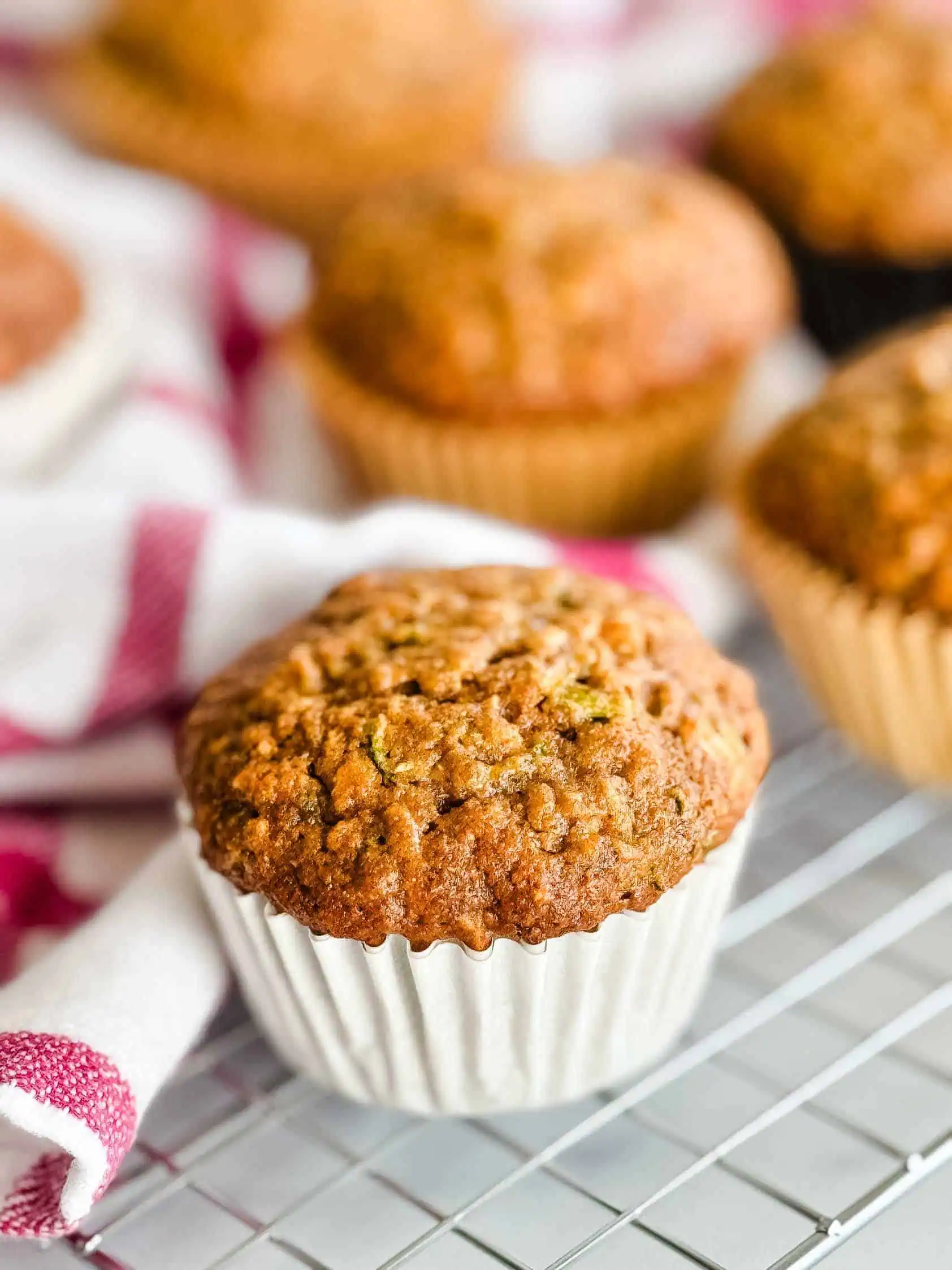 Zucchini muffins on a wire rack.