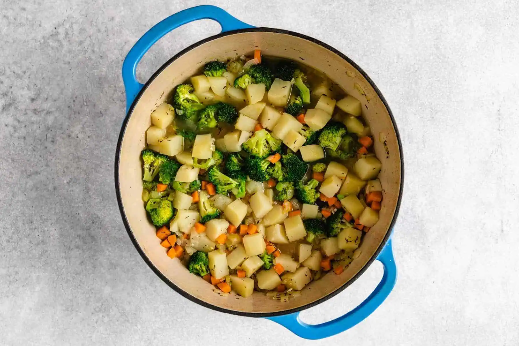 Potatoes, broccoli and carrots in a pan.