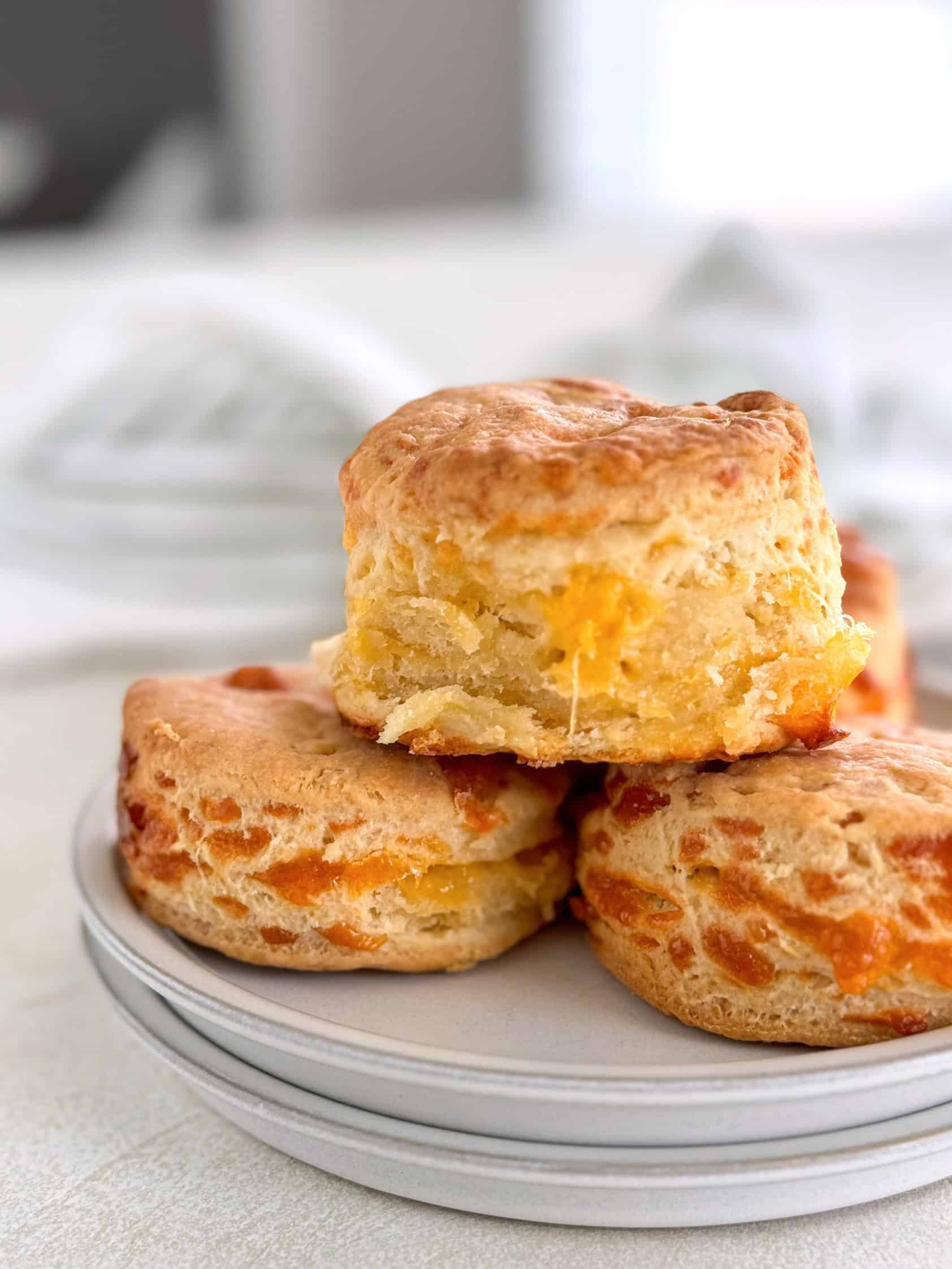 A close-up view of cheddar biscuits showcasing the flaky layers and cheesy goodness.