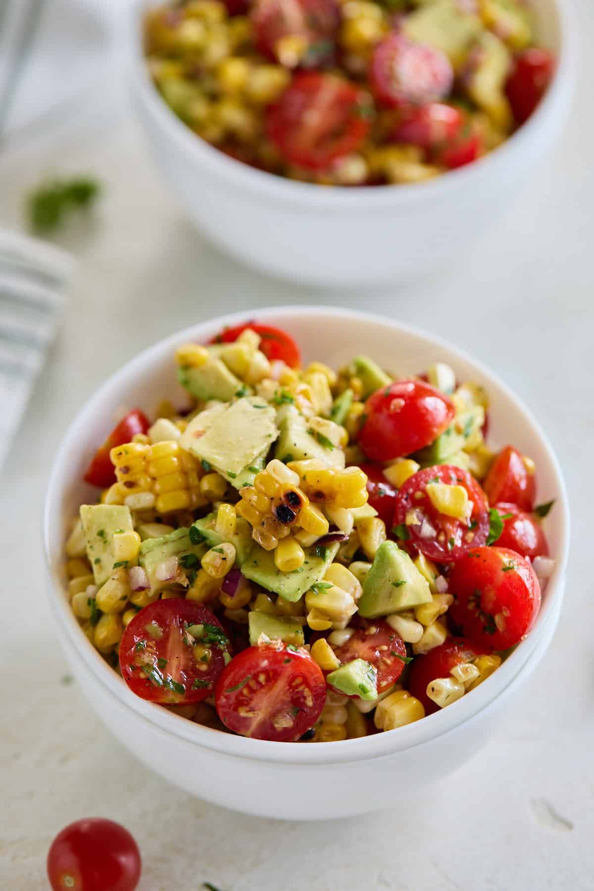 Another close-up of the salad in a white bowl, highlighting the charred corn and fresh vegetables.