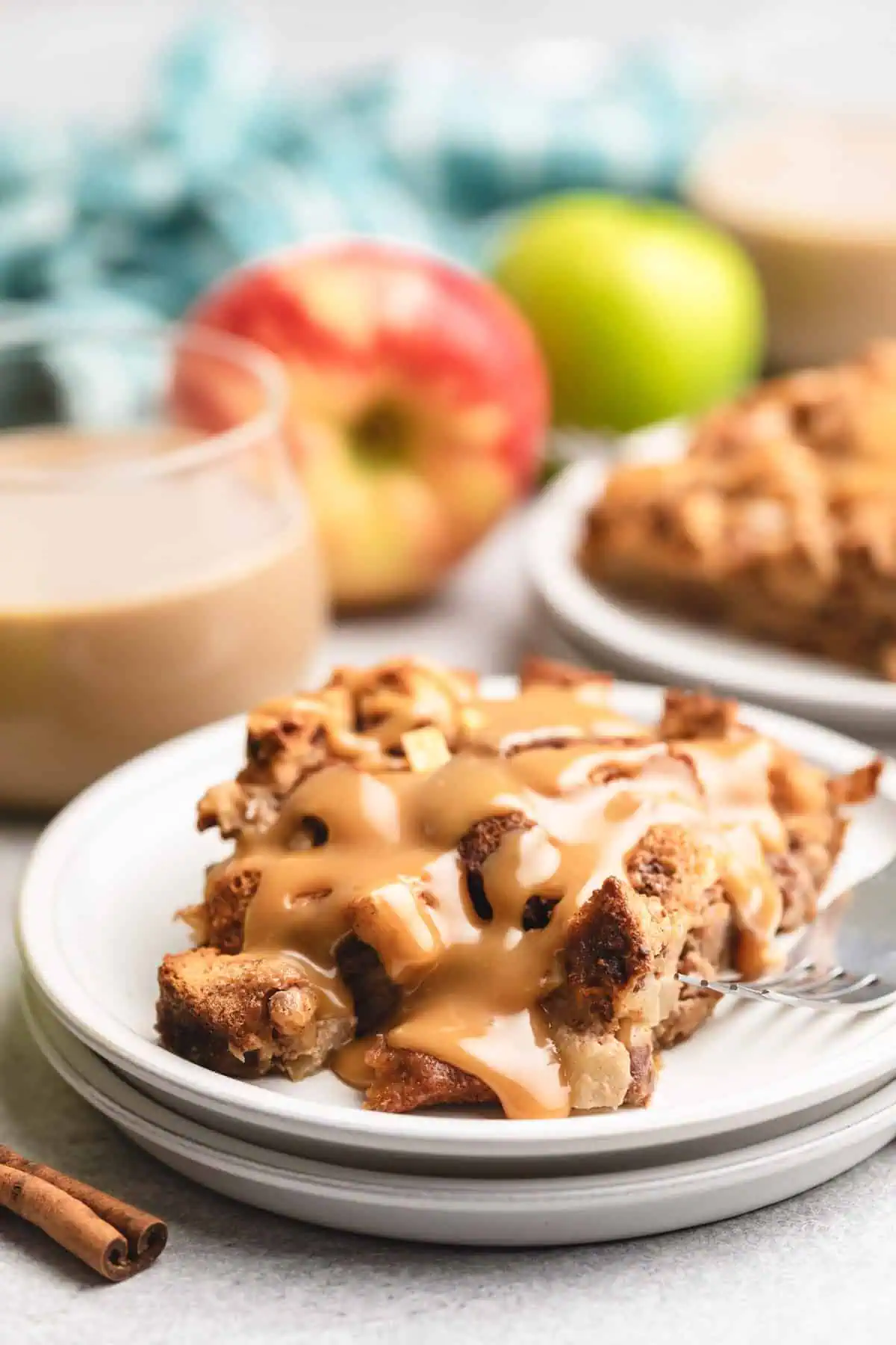 Apple cinnamon bread pudding on a white plate.