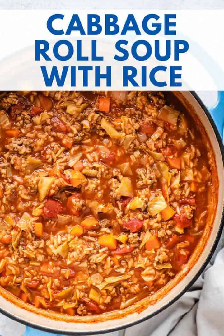 A vibrant cabbage roll soup with rice in a large blue pot, featuring a hearty mix of cabbage, ground meat, and tomato stew, making it an excellent choice for a cabbage roll soup recipe or cabbage stew.