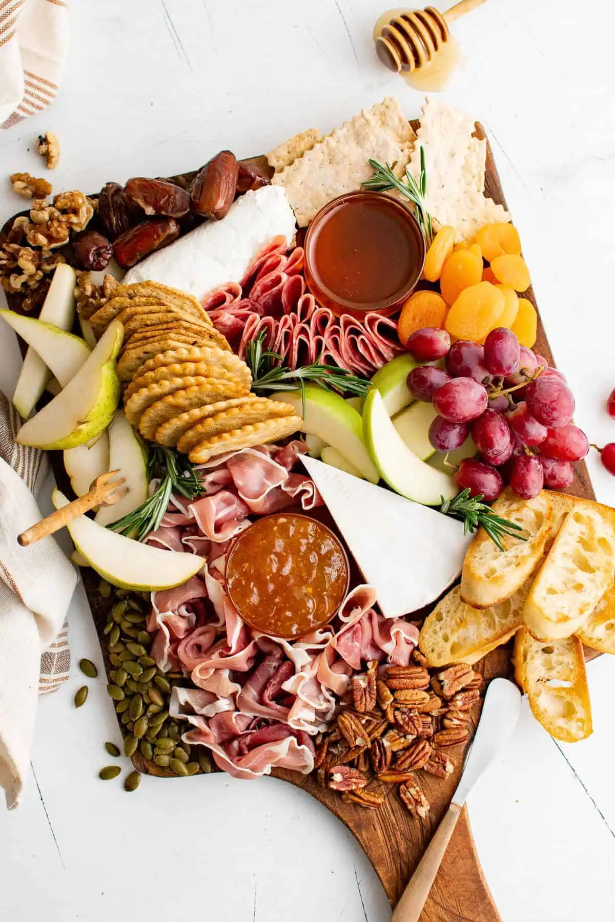 Fall harvest charcuterie board with meat, cheese, and nuts.