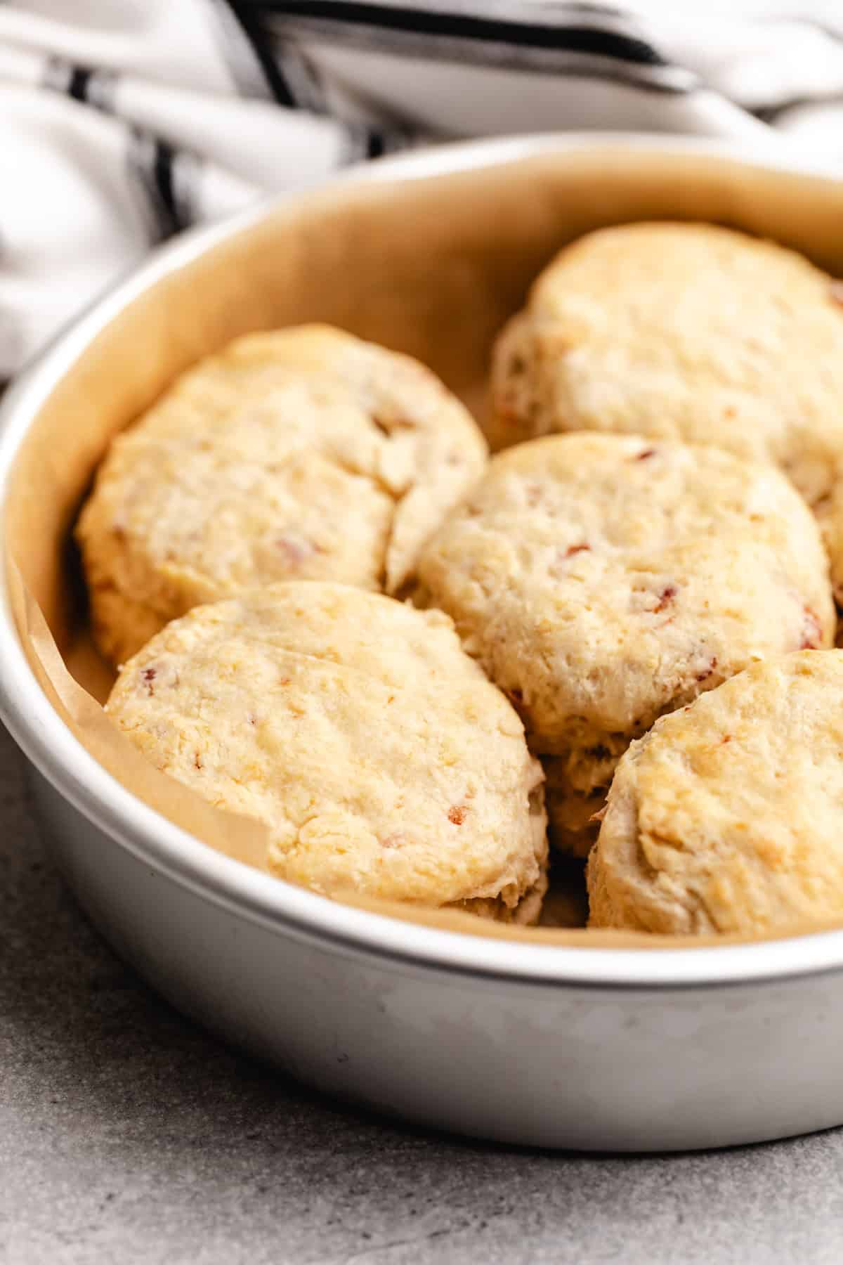 Side view of biscuits in a pan.