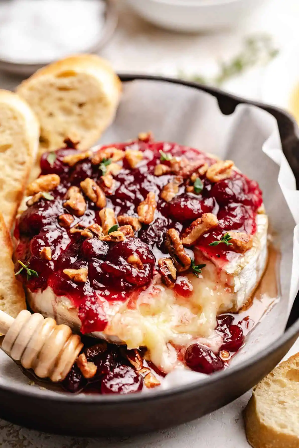 Melted brie cheese topped with cranberry sauce and pecans.