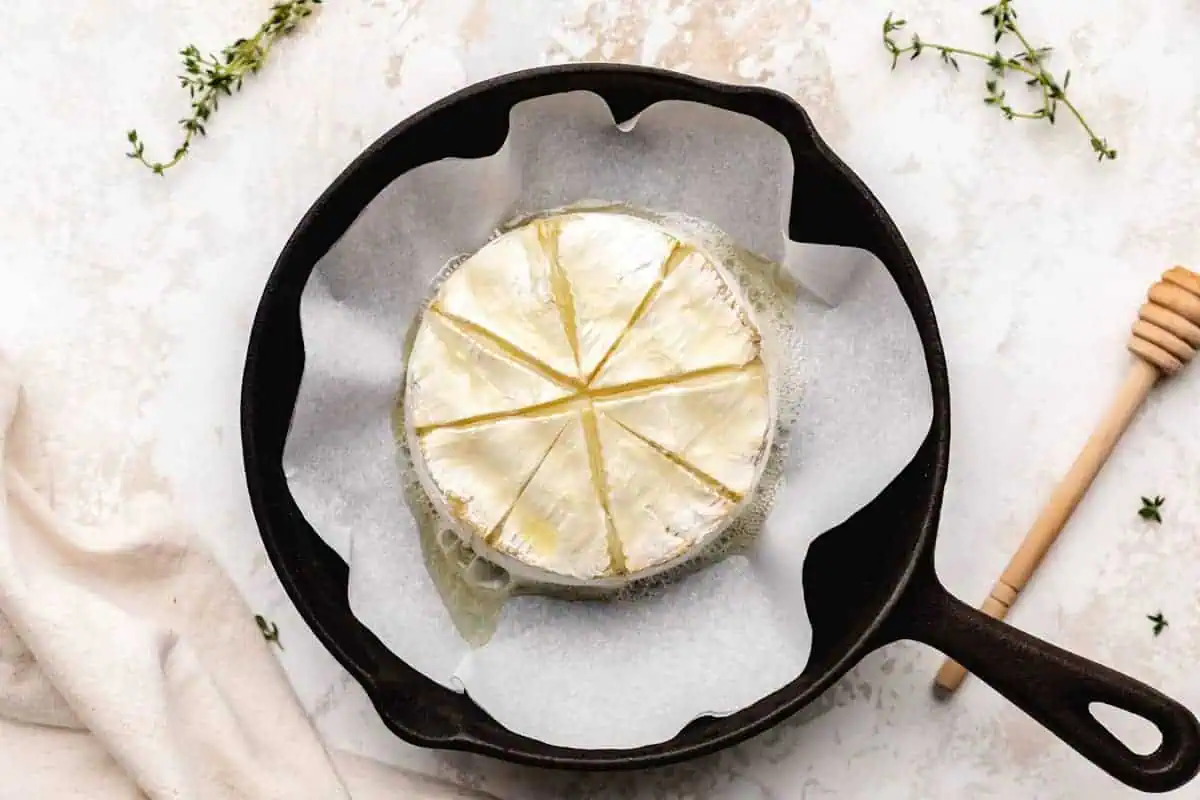 Baked brie cheese in a pan.