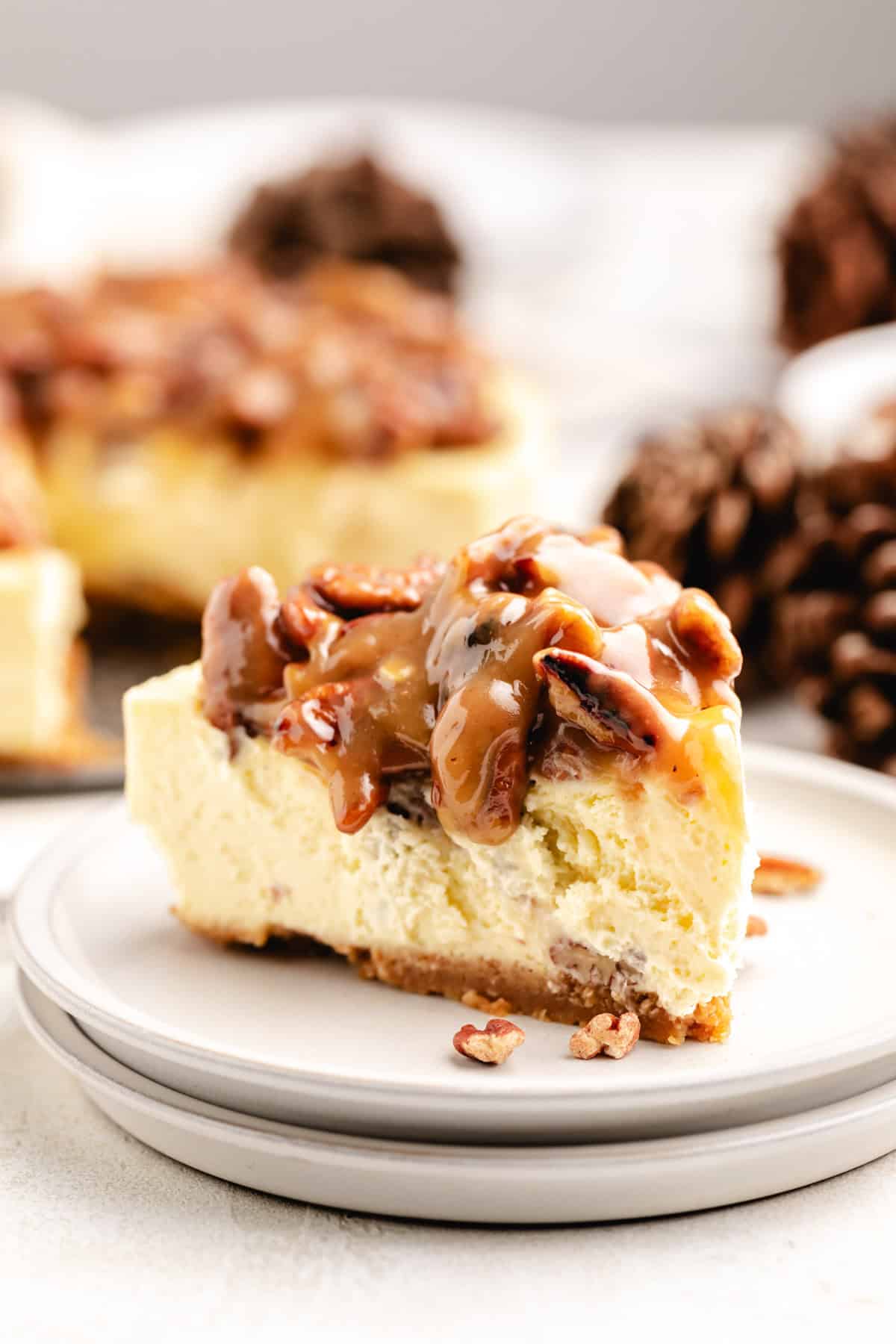 Caramel pecan topping dripping over cheesecake.