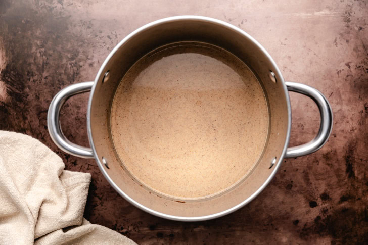 Milk and heavy cream added to a spiced pumpkin mixture.