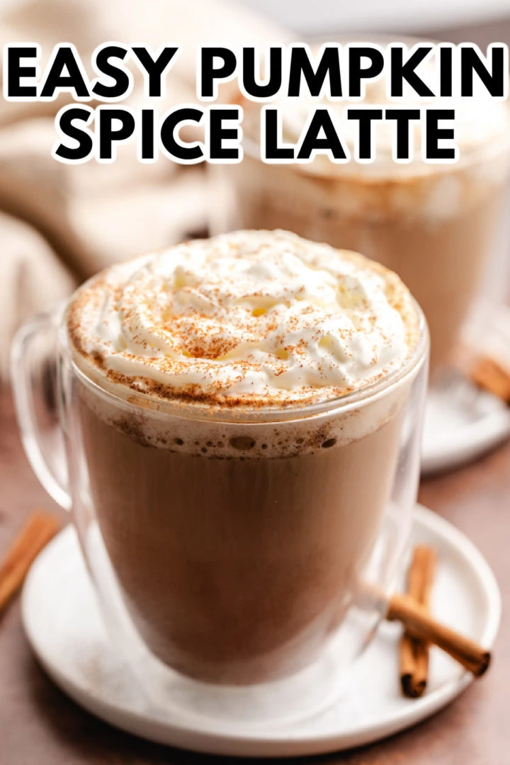 Pumpkin spice latte in a glass mug.