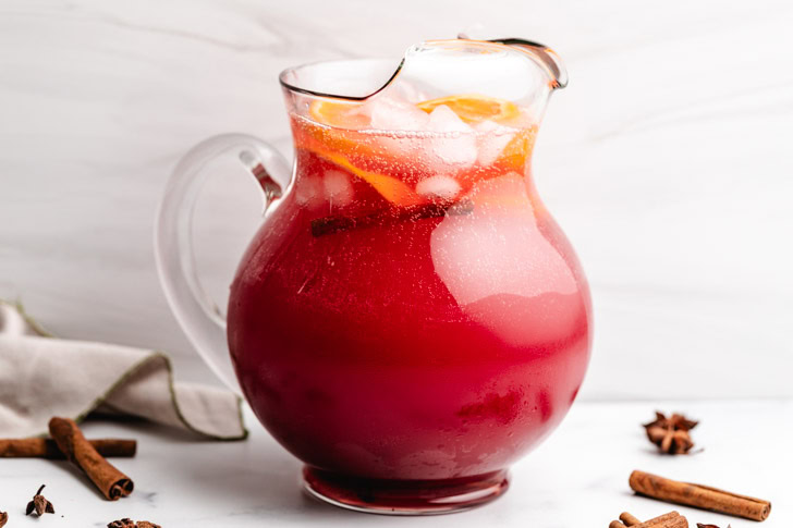 Pitcher filled with cranberry punch.