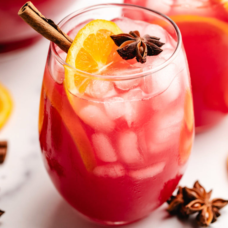 Close up view of spiced cranberry sparkler with orange slices.