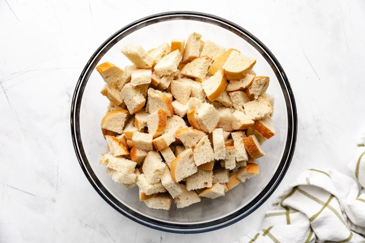 Cubed french bread in a bowl.