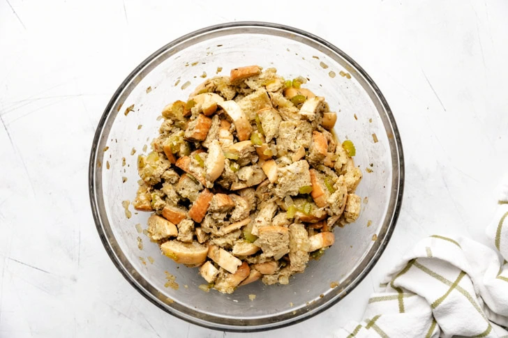 Unbaked stuffing in a glass bowl.