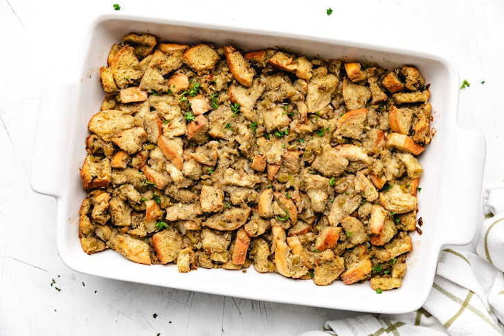 Overhead view of french bread stuffing in a baking dish.