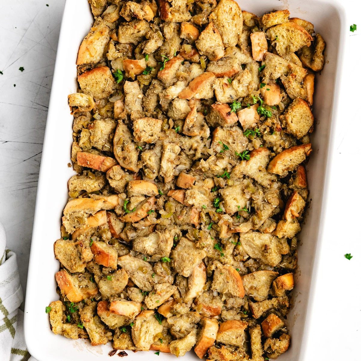 Close up view of thanksgiving stuffing in a ceramic pan.