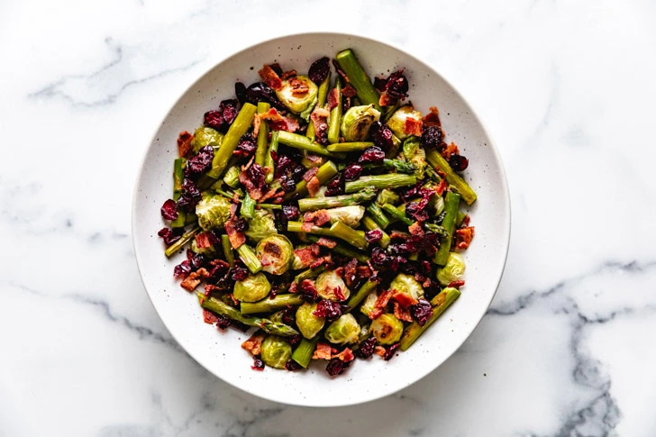 Cranberries and bacon added to roasted veggies.