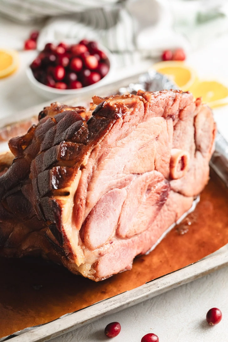 Brown sugar ham on a foiled lined baking sheet.