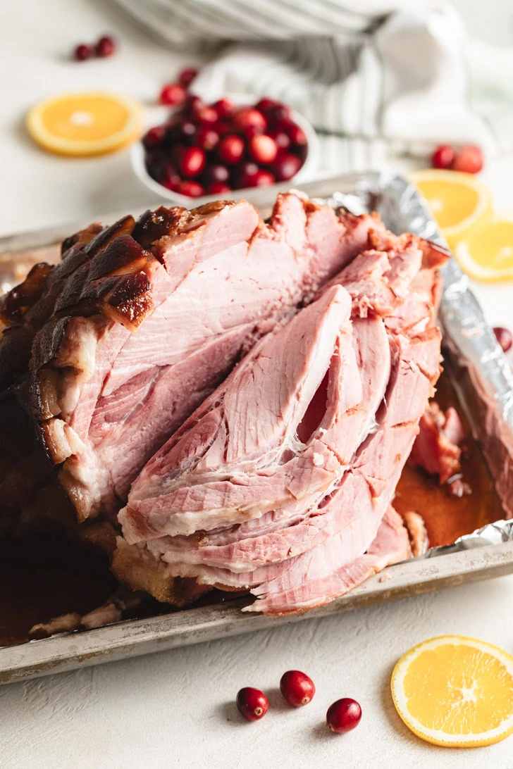 Sliced ham on a baking sheet.