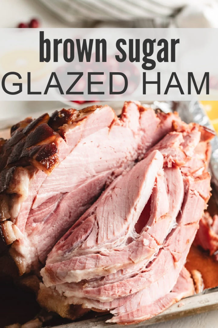 Sliced maple brown sugar baked ham on a baking sheet.