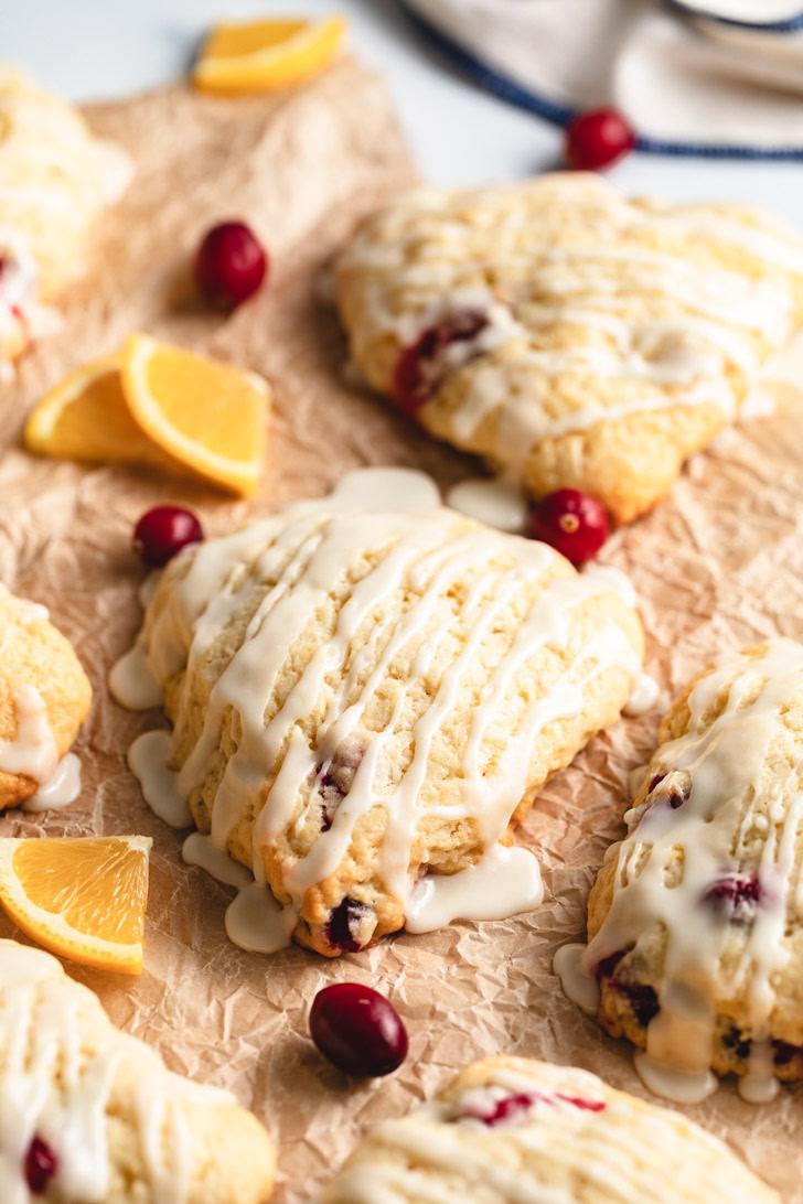 Orange and cranberry scones on parchment.