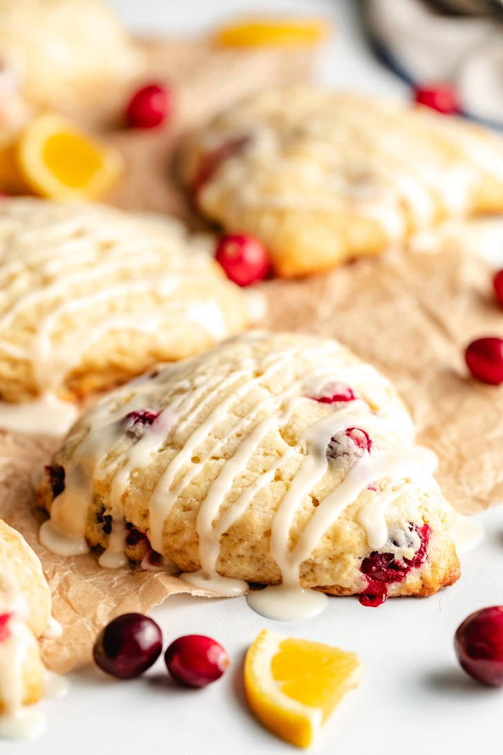 Close-up of a cranberry orange scone highlighting the texture and orange zest glaze.