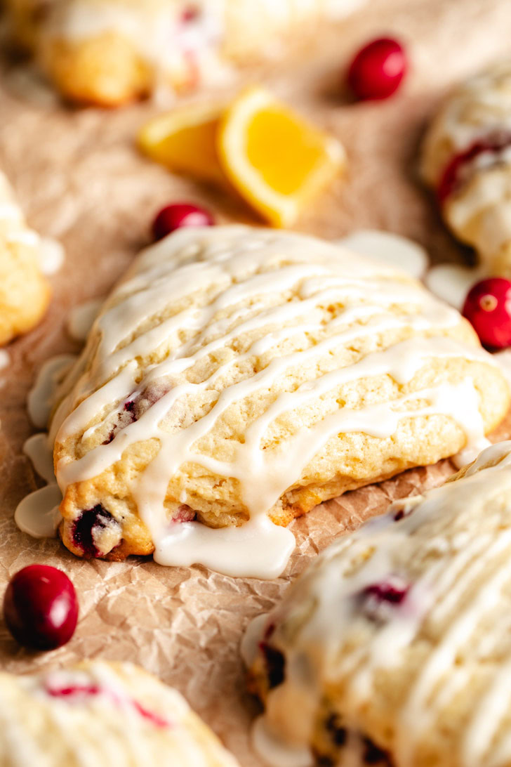 A close-up of the flaky layers of a scone with orange zest.