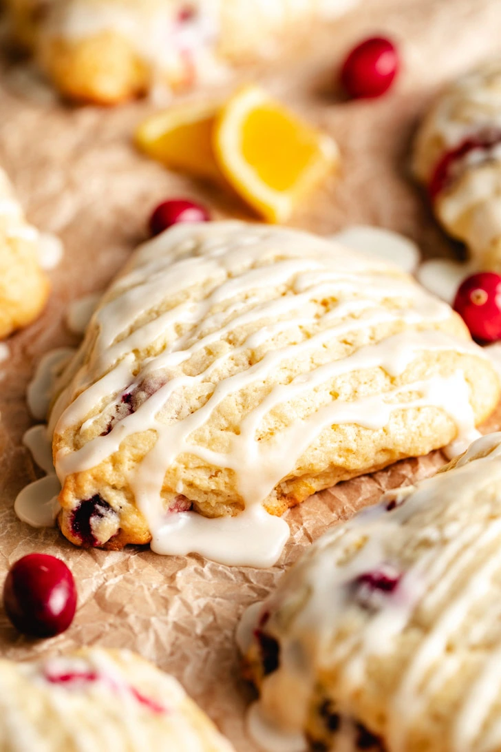 A close-up of the flaky layers of a scone with orange zest.