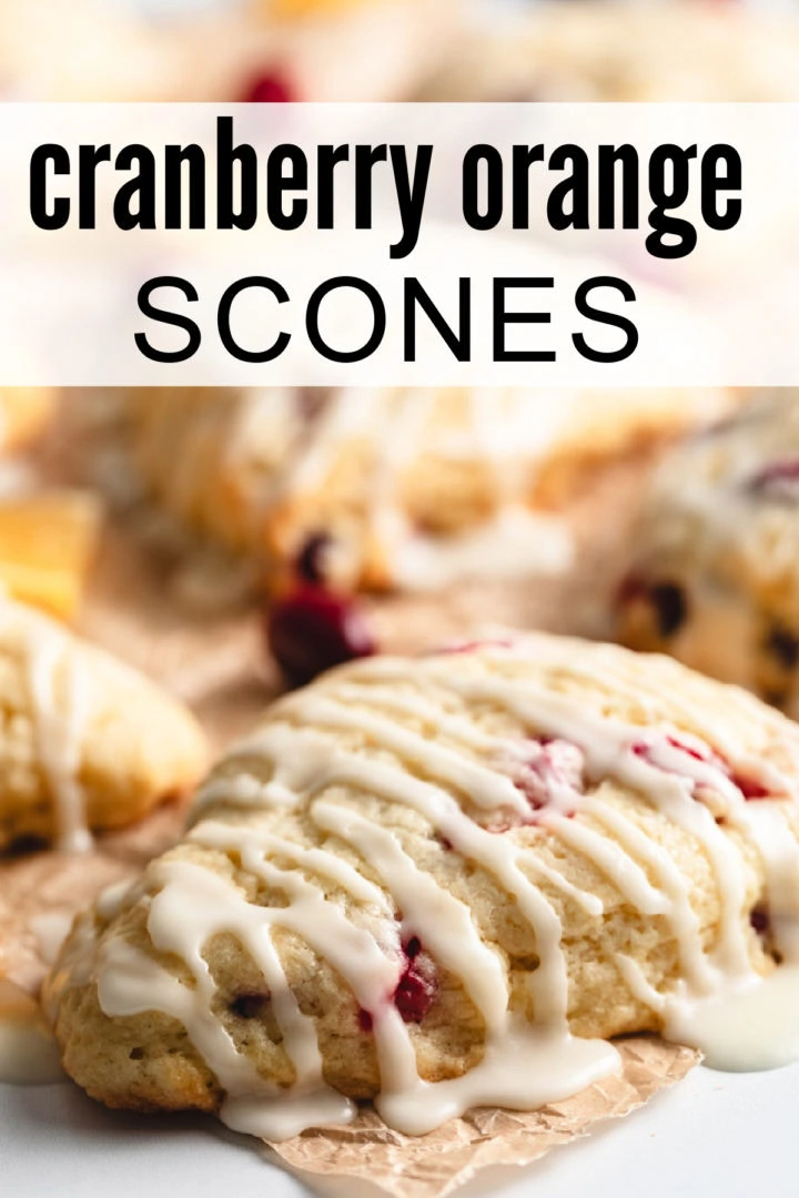 Multiple scones arranged on parchment paper, drizzled with glaze.