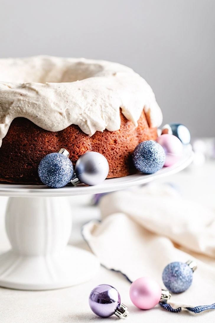 Frosting spread over an eggnog bundt cake.