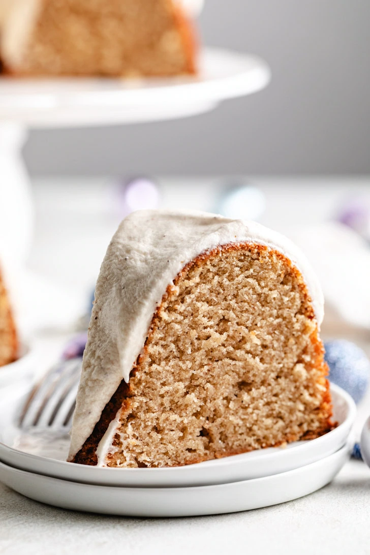 Ornaments surrounding a slice of cake on a plate.