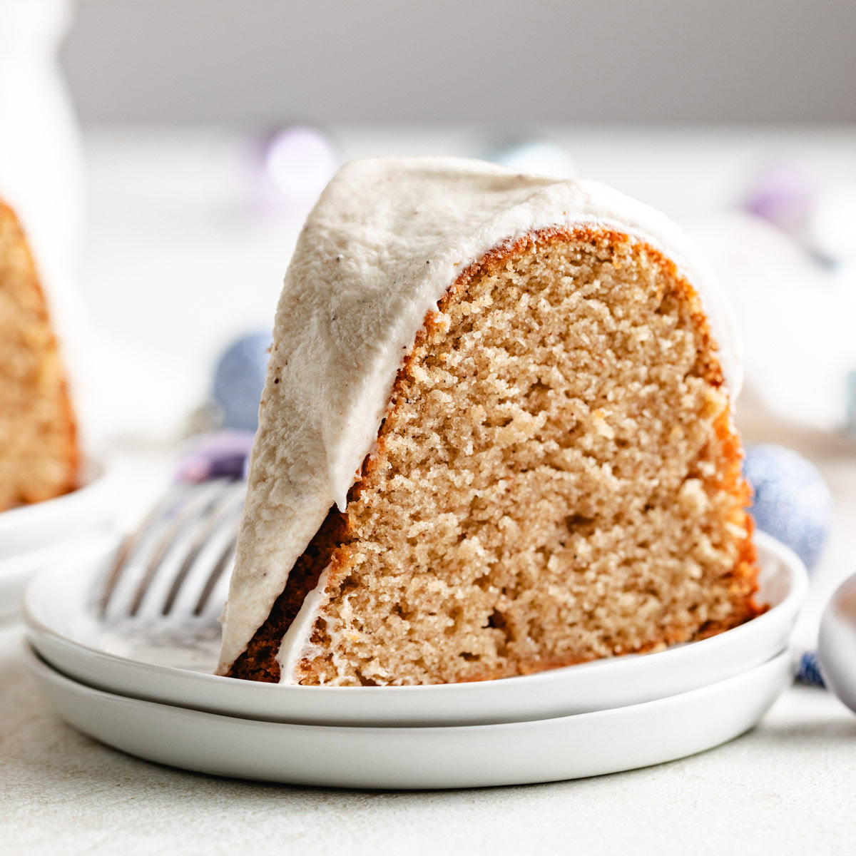 Close up view of eggnog cake on white plates.