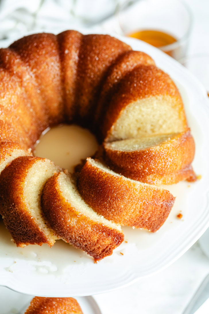 Sliced cake on a white cake plate.